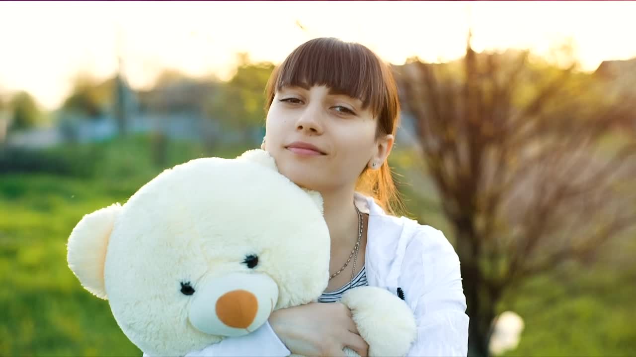 Stock Video Girl Hugging A Teddy Bear Outdoors Live Wallpaper For PC - Free Download