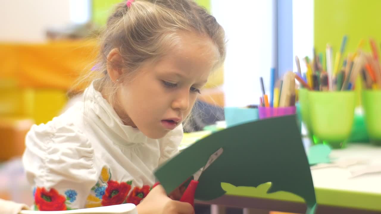 Stock Video Little Girl Cutting Paper In A Kindergarten Classroom Animated Wallpaper - Free Download