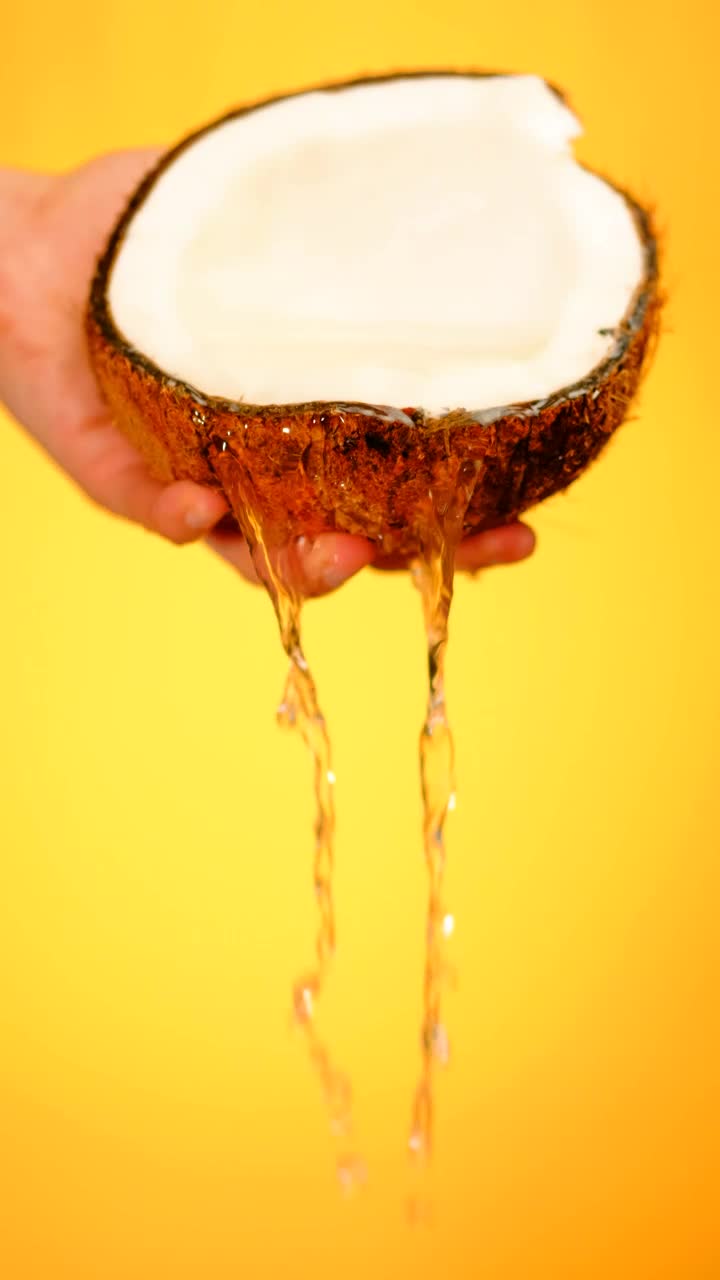 Free Video Stock Spilling Water From A Coconut On A Yellow Background Live Wallpaper - Free Download