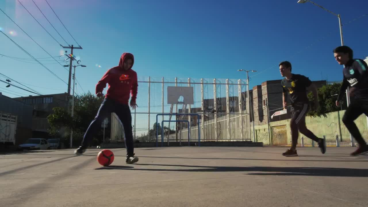 Free Video Stock three men playing soccer in concrete field Live Wallpaper - Free Download