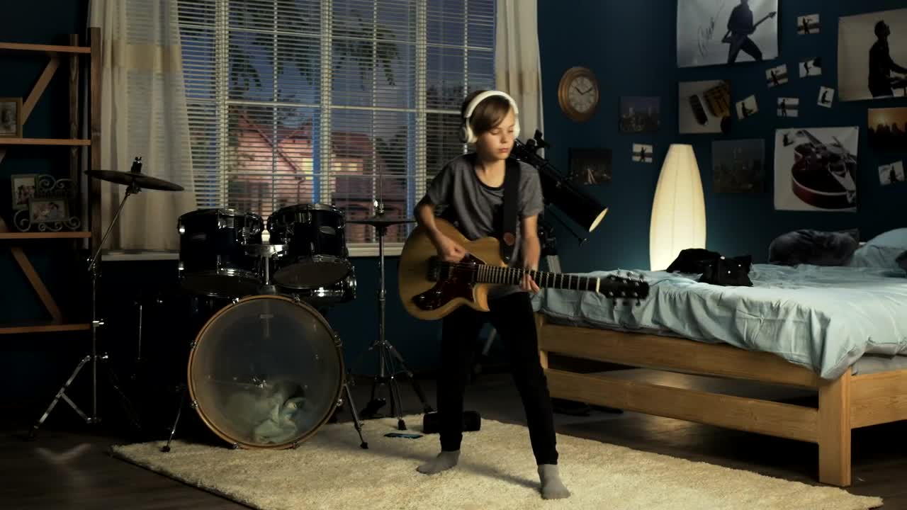 Free Video Stock teen boy playing guitar in his bedroom Live Wallpaper - Free Download