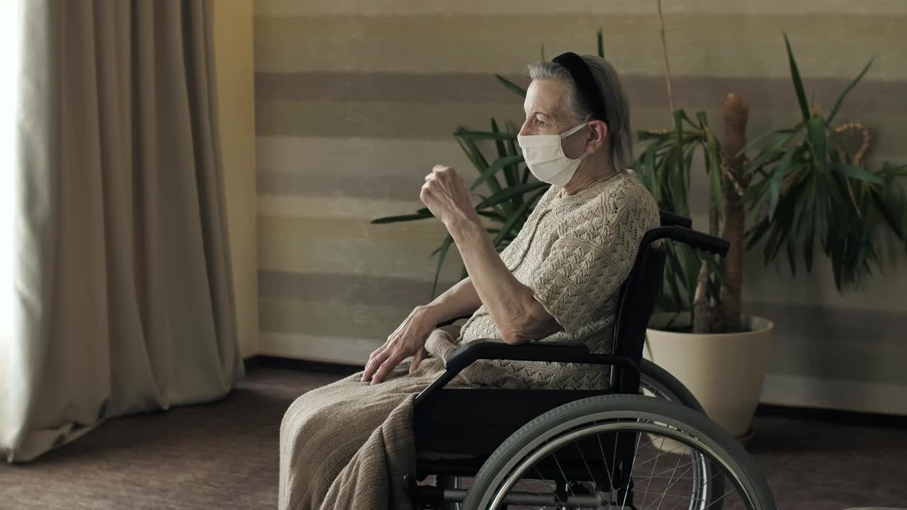 Stock Video Elderly Woman In A Wheelchair Wearing Mask Live Wallpaper For PC - Free Download