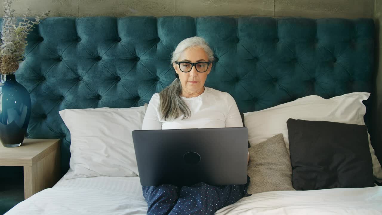 Stock Video Elderly Woman On Laptop In Blue Bedroom Live Wallpaper For PC - Free Download