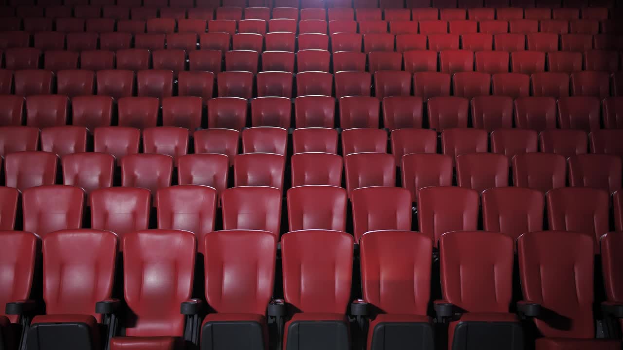 Stock Video People With Masks Sitting Apart In A Movie Theater Live Wallpaper - Free Download