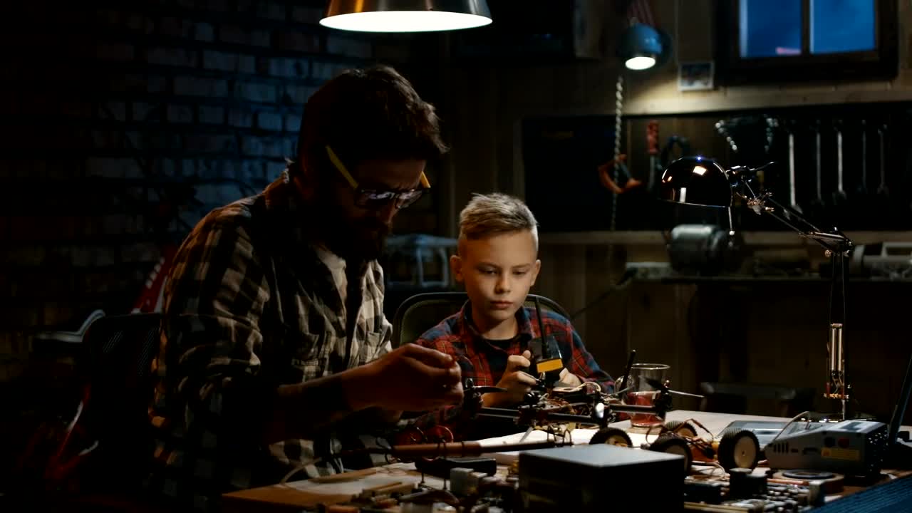 Stock Video Father And Son Repairing A Drone In The Garage Live Wallpaper For PC - Free Download