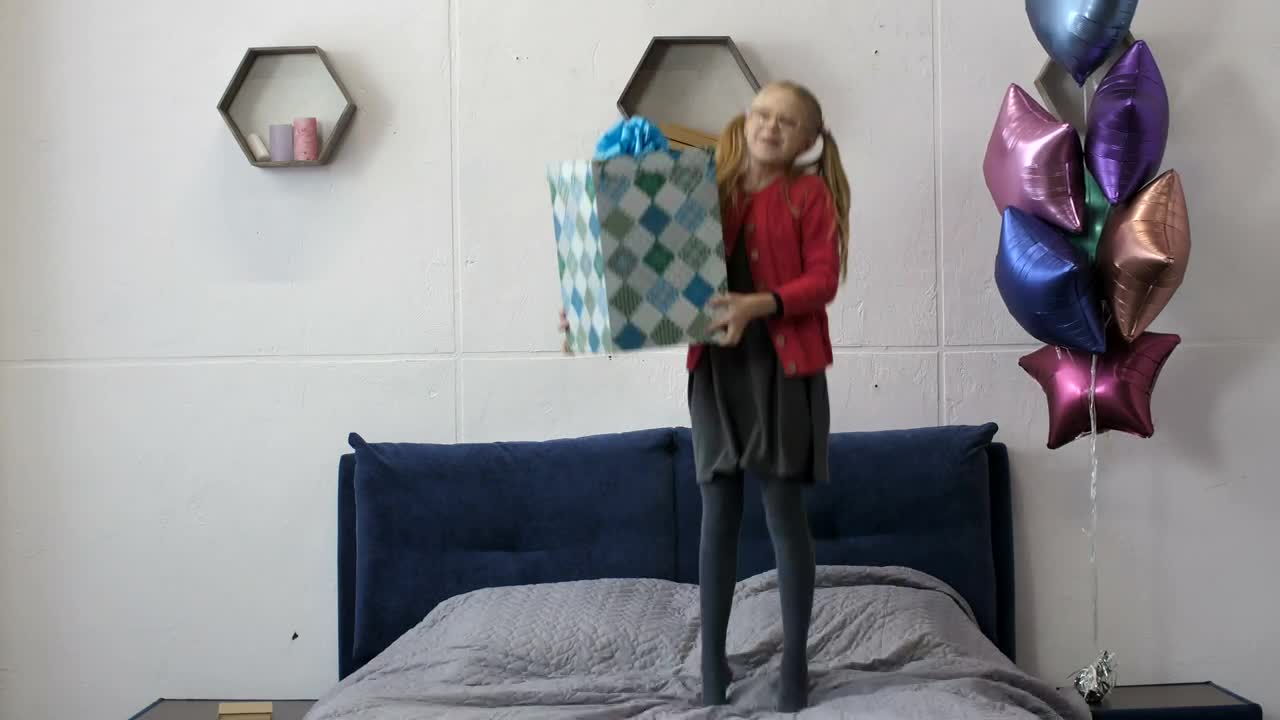 Stock Video Happy Girl Jumping On Her Bed With A Gift Animated Wallpaper - Free Download