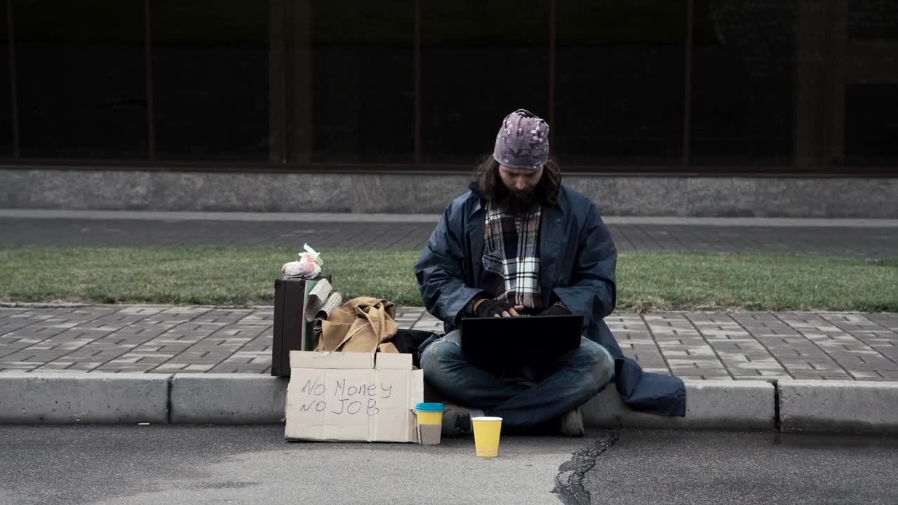 Stock Video Homeless Man With A Laptop Sitting On The Sidewalk Animated Wallpaper - Free Download