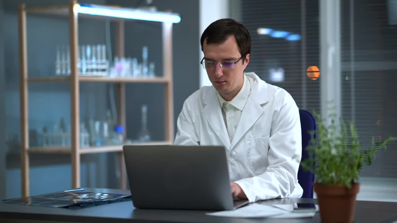 Stock Video Doctor Looking At An X Ray And Working On The Computer Live Wallpaper For PC - Free Download