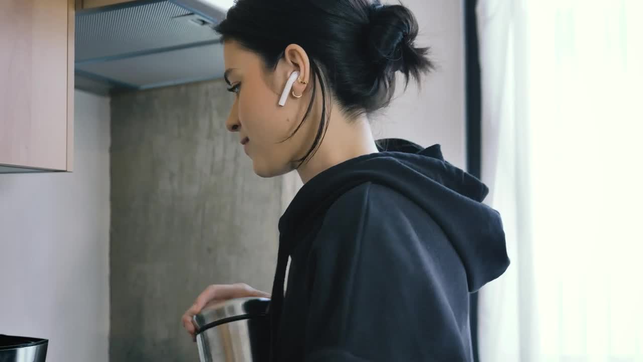 Free Stock Video Woman On Call With Earphones While Preparing Coffee Live Wallpaper - Free Download