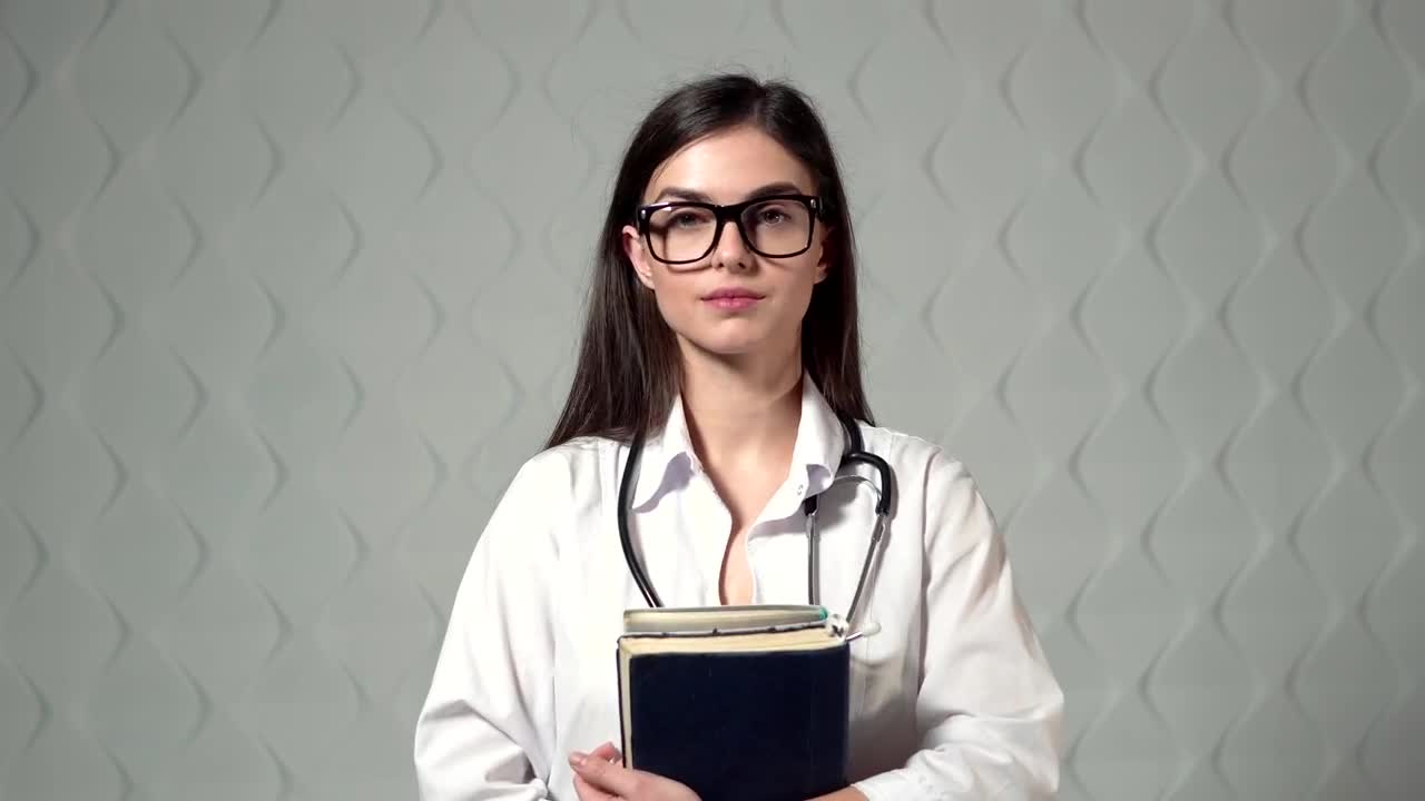 Stock Video Lovely Smiling Doctor Stands In Hospital Hallway Animated Wallpaper - Free Download