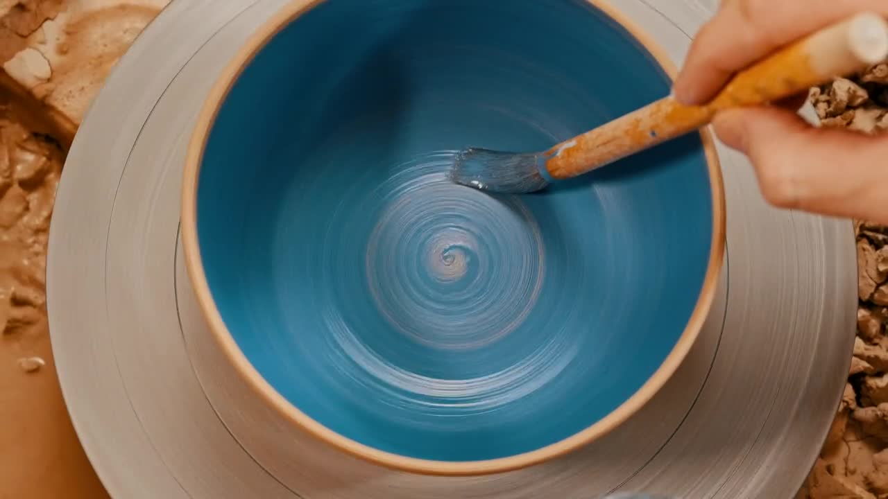 Stock Video Painting A Spinning Pot Blue Using A Brush Live Wallpaper - Free Download