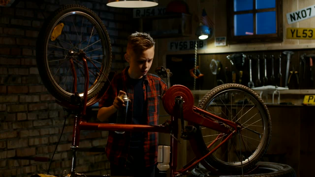 Stock Video Kid Repairs His Bicycle In The Garage Animated Wallpaper - Free Download