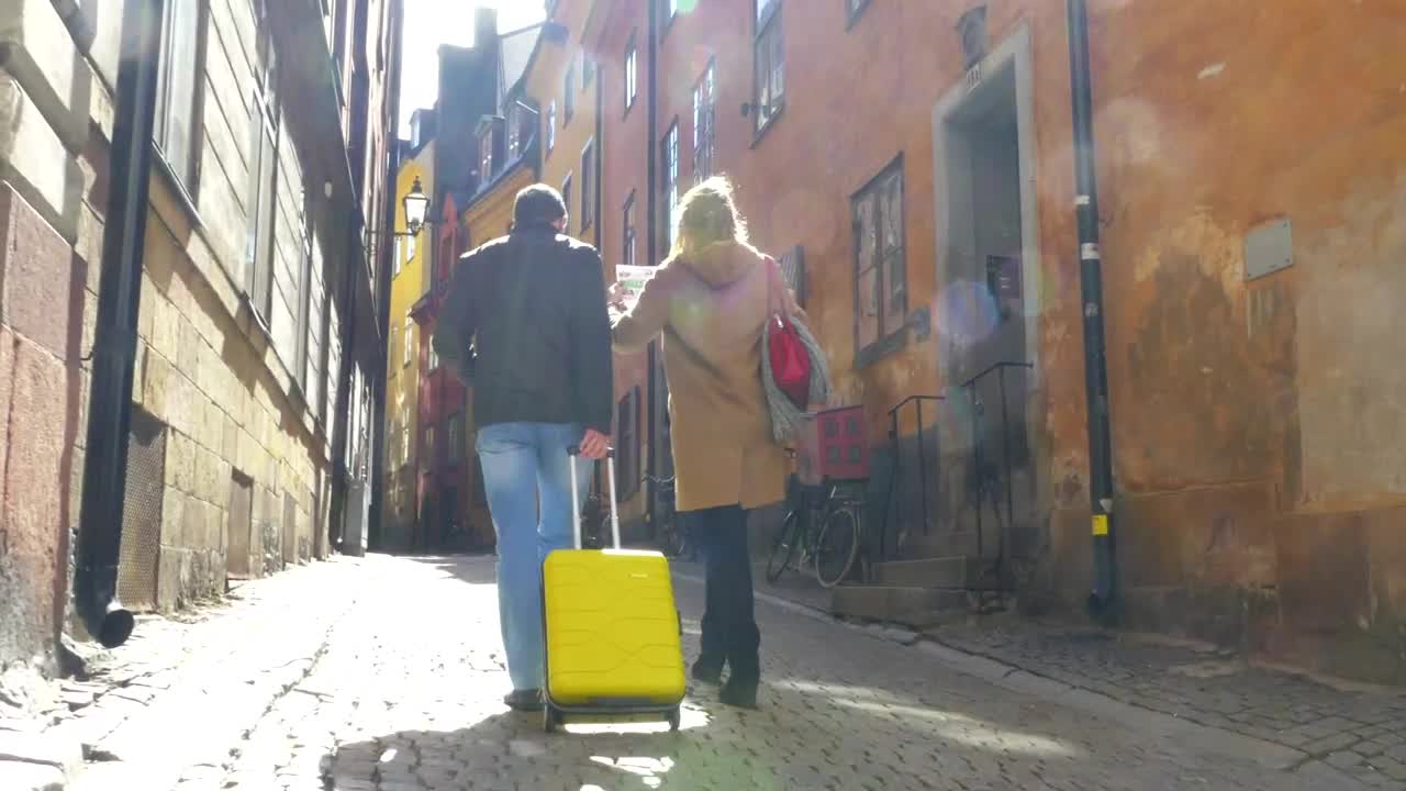 Free Video Stock tourists walking through a city with their luggage Live Wallpaper - Free Download