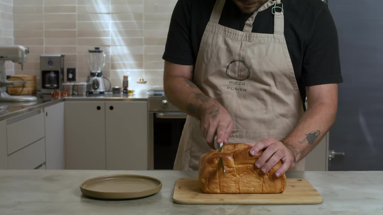 pastry chef cutting a loaf into slices 43015 - Free Download
