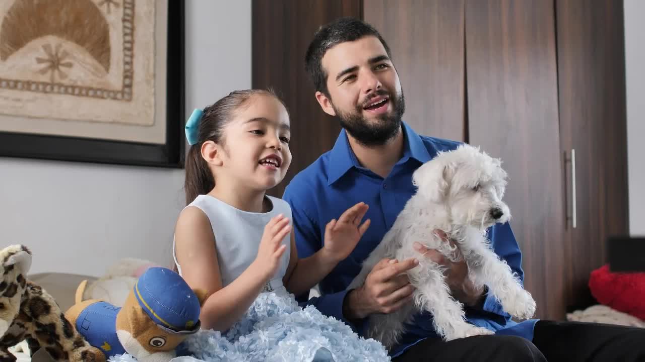 Stock Video Father And Daughter Together Watching Television With Their Little Dog Live Wallpaper For PC - Free Download