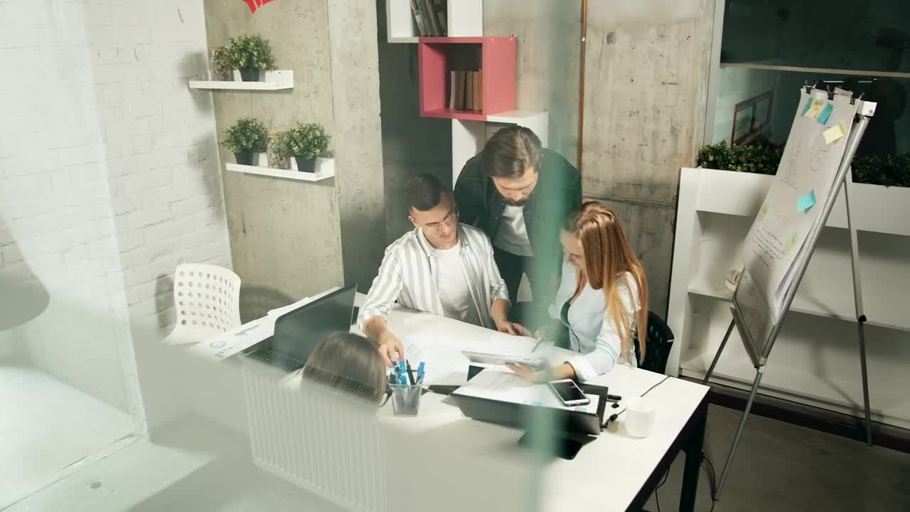 Free Video Stock team leader helps young designers solve problems Live Wallpaper - Free Download