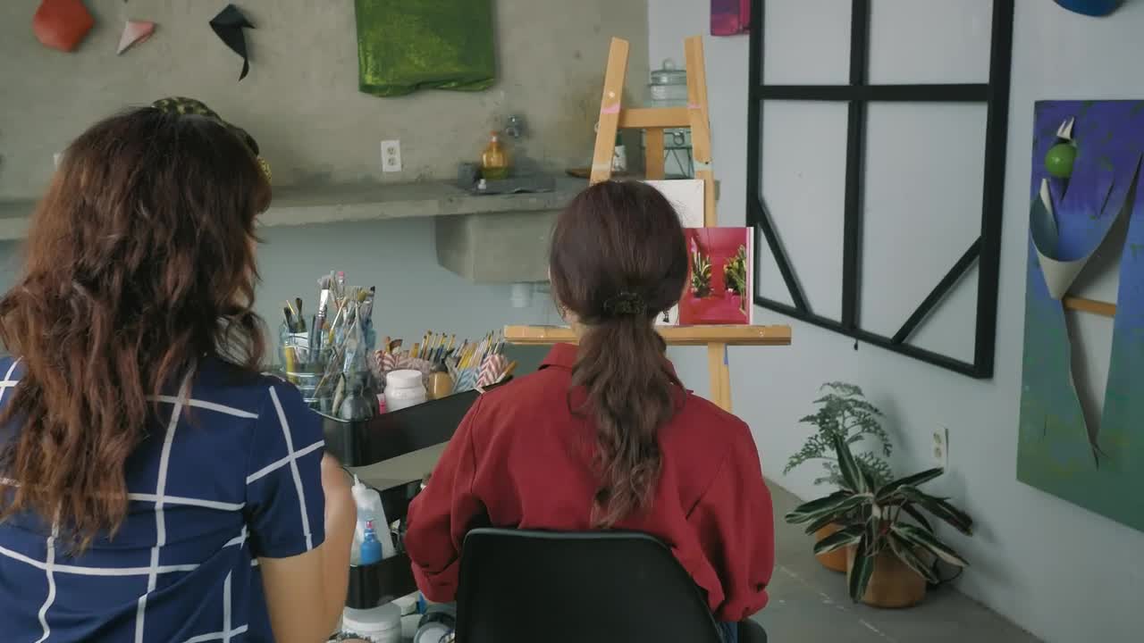 Stock Video Pair Of Artist Girls Working Together On A Painting Live Wallpaper - Free Download