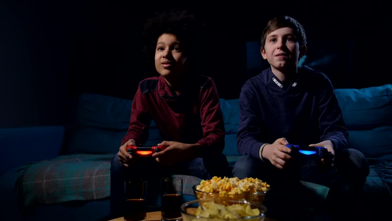 Free Video Stock teens playing a video game in a dark living room Live Wallpaper - Free Download