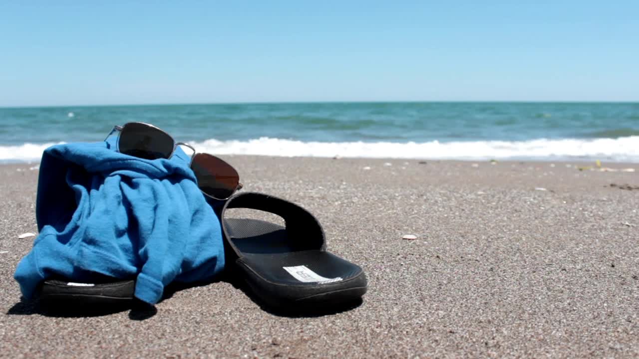 Stock Video Flip Flops T Shirt And Glasses On The Sand Live Wallpaper For PC - Free Download