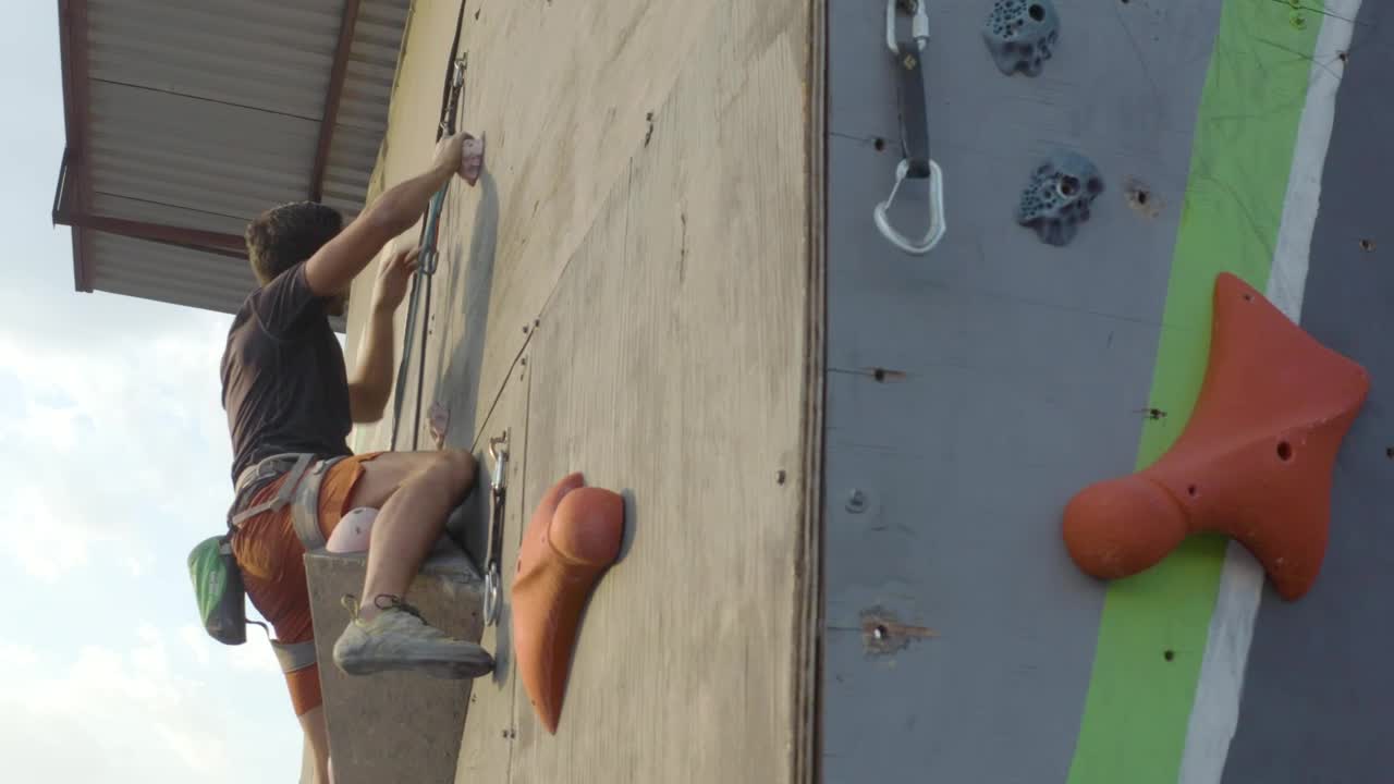 Stock Video Man Climbing On Top Of A Mountaineering Tower Animated Wallpaper - Free Download