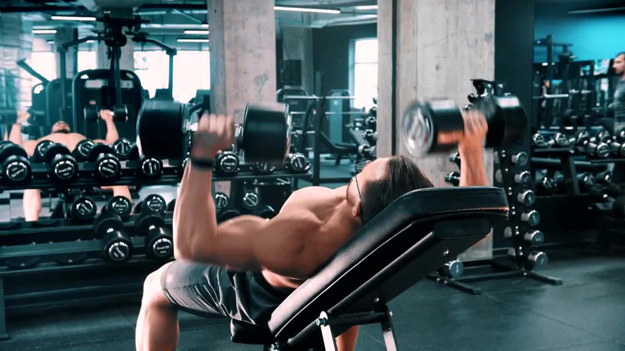 Stock Video Male Bodybuilder Doing Chest Exercises With Dumbbells Animated Wallpaper - Free Download