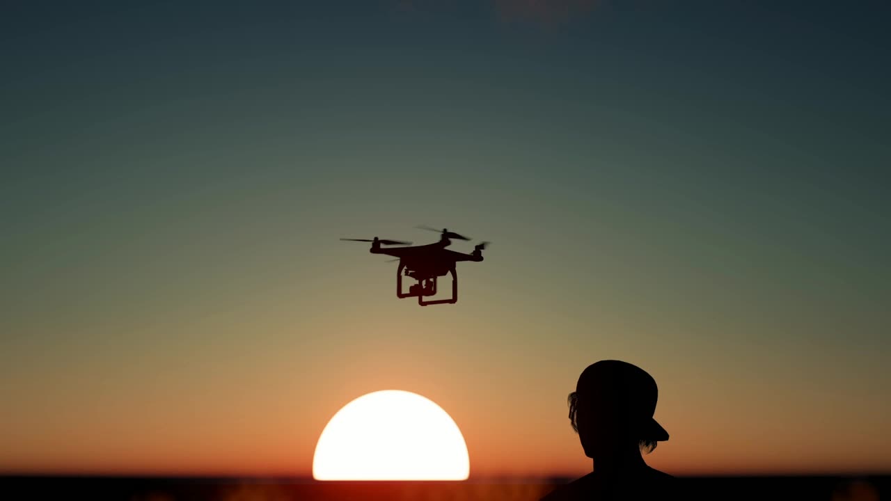 Free Stock Video Silhouette Of A Boy Flying A Drone At Sunset Live Wallpaper - Free Download