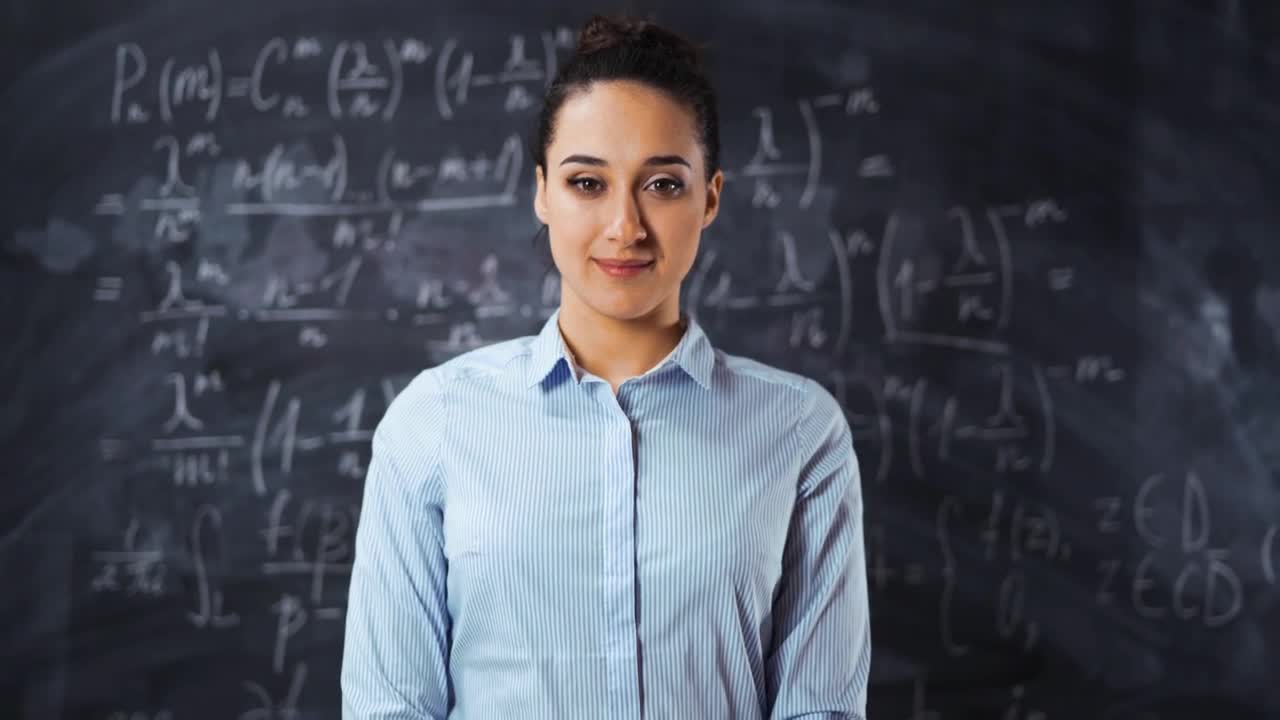 Free Video Stock teacher smiling in front of a blackboard Live Wallpaper - Free Download
