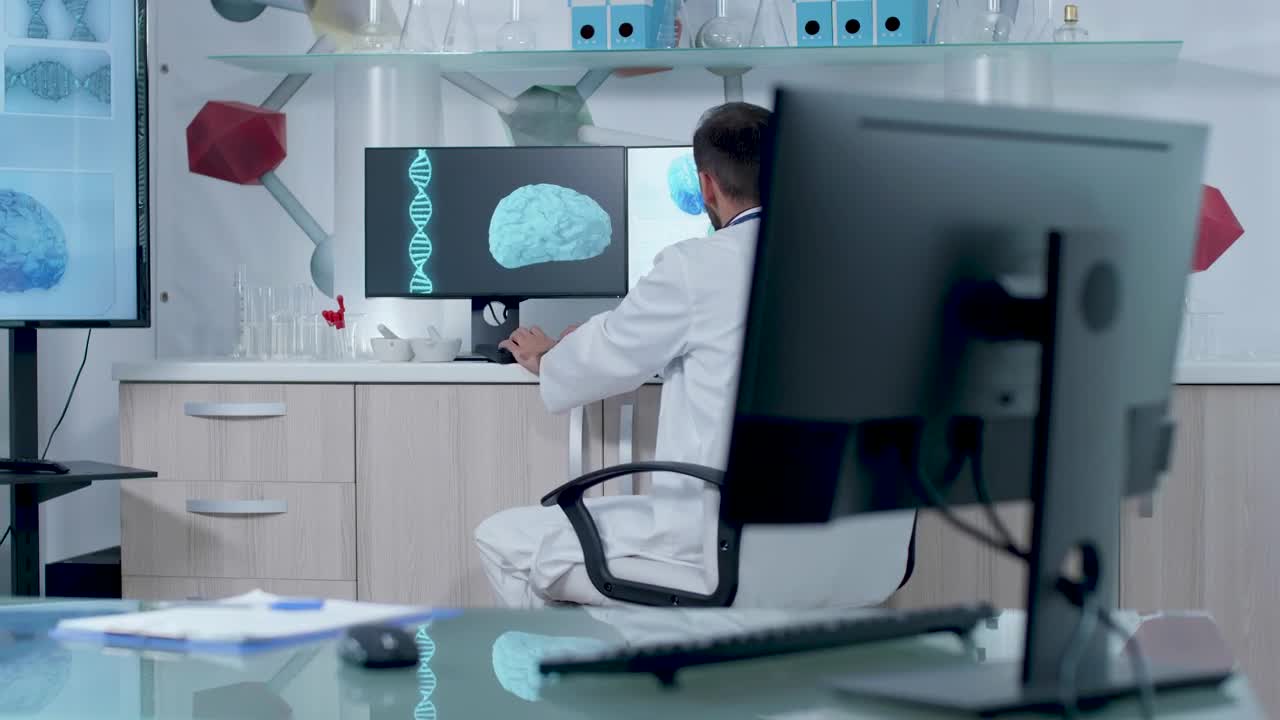 Free Stock Video Scientist Typing In Front Of Dna Models In Modern Lab Live Wallpaper - Free Download