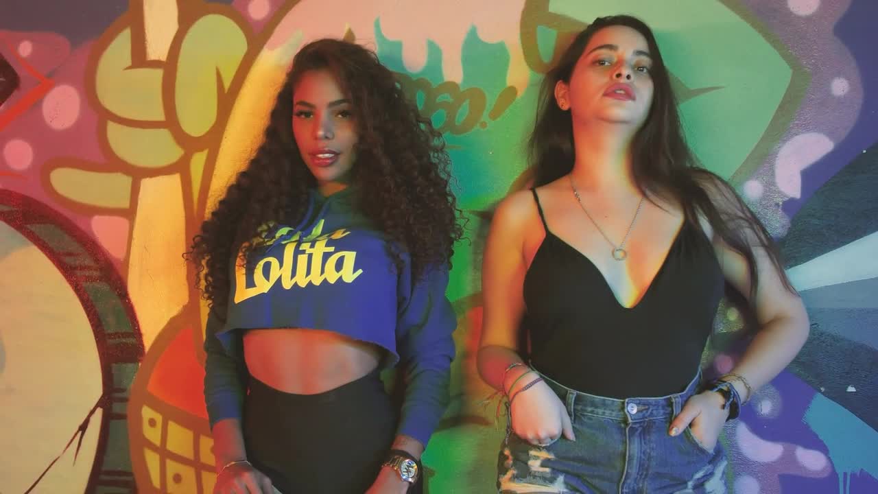 Stock Video Pair Of Girls Leaning Against A Wall With Graffiti Live Wallpaper - Free Download