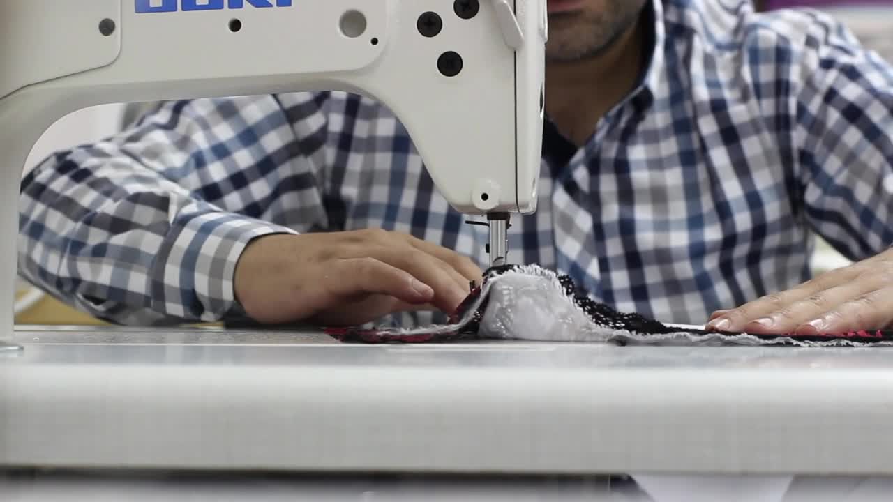 Stock Video Man Sewing A Garment On A Sewing Machin Animated Wallpaper - Free Download