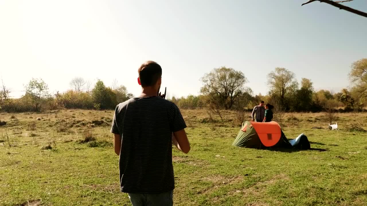Stock Video Man Helps Friends Start Fire On Camping Trip Animated Wallpaper - Free Download