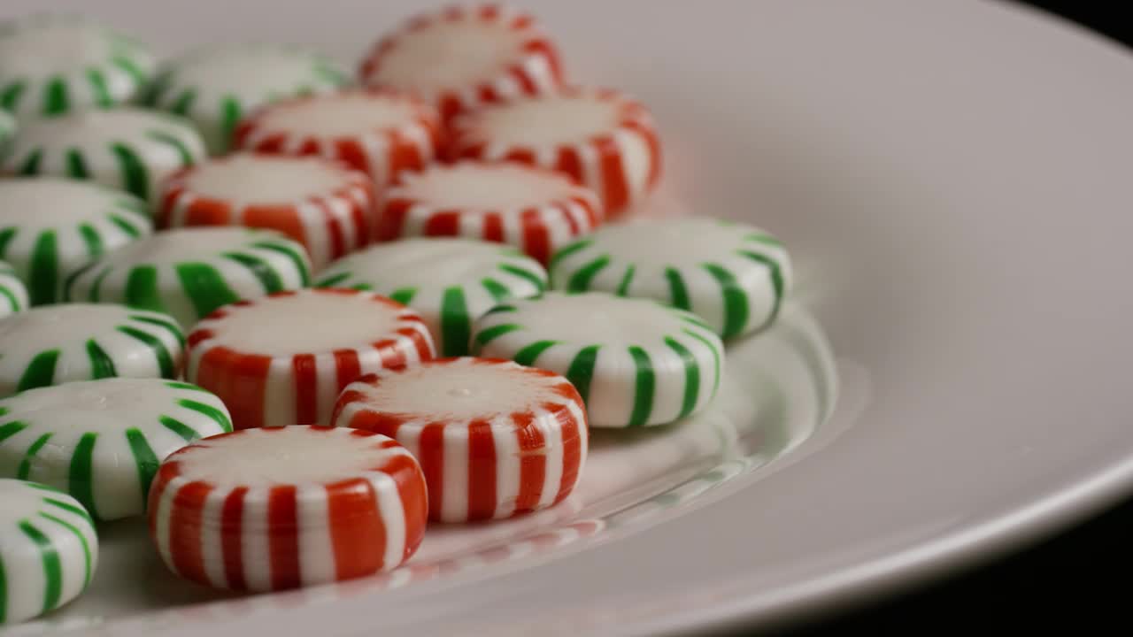 Stock Video Green And Red Candies Rotating On A White Plate Live Wallpaper For PC - Free Download