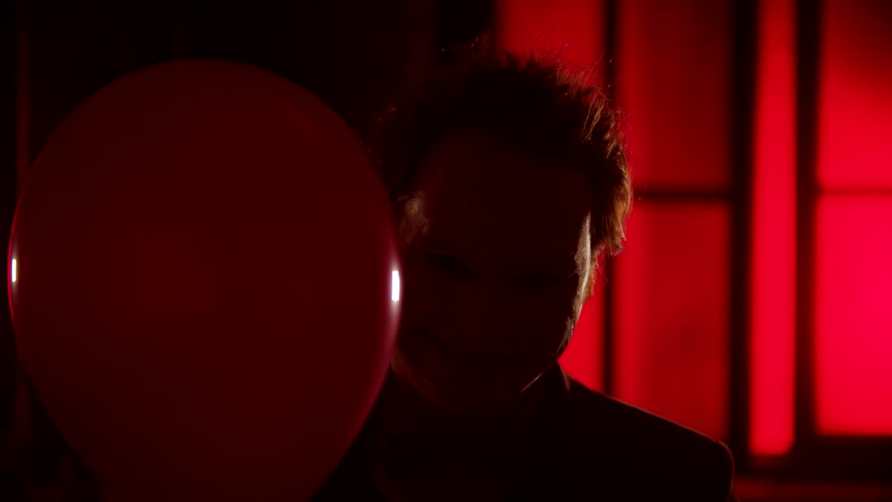 Stock Video Evil Clown Smiling Behing A Red Balloon Live Wallpaper For PC - Free Download