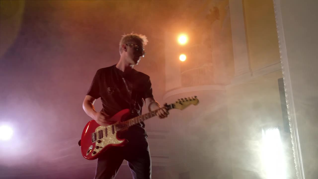 Stock Video Old Musician Playing The Guitar On A Stage Live Wallpaper - Free Download