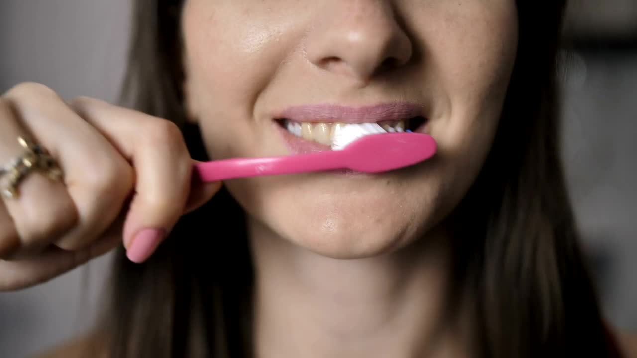 Stock Footage Woman Brushing Her Teeth Live Wallpaper - Free Download