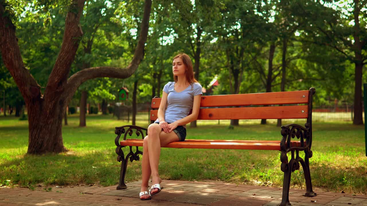 Stock Video Girl Sitting On A Bench Waiting For Someone Live Wallpaper For PC - Free Download