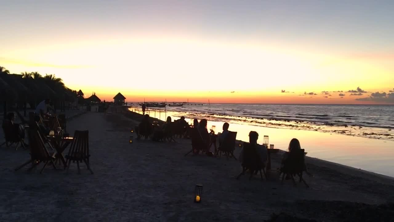Free Video Stock tourists at a beach bar watching at sunset Live Wallpaper - Free Download