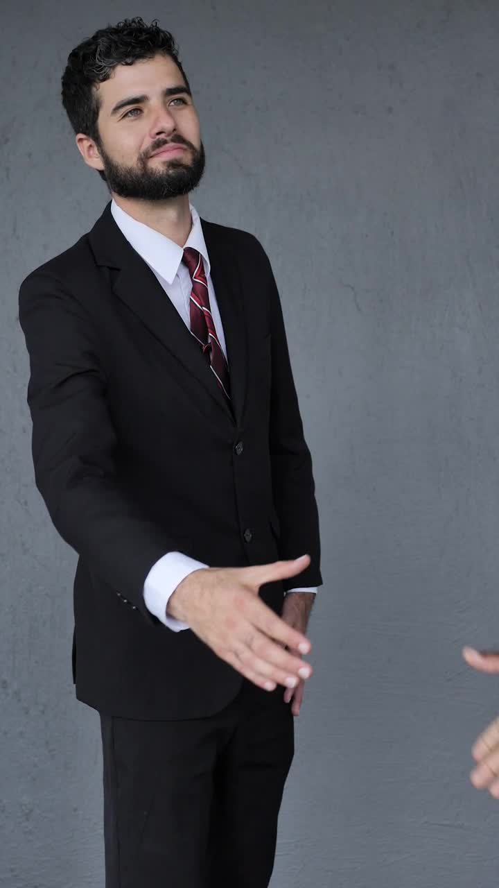 Stock Video Man In A Suit Giving A Firm Handshake Animated Wallpaper - Free Download