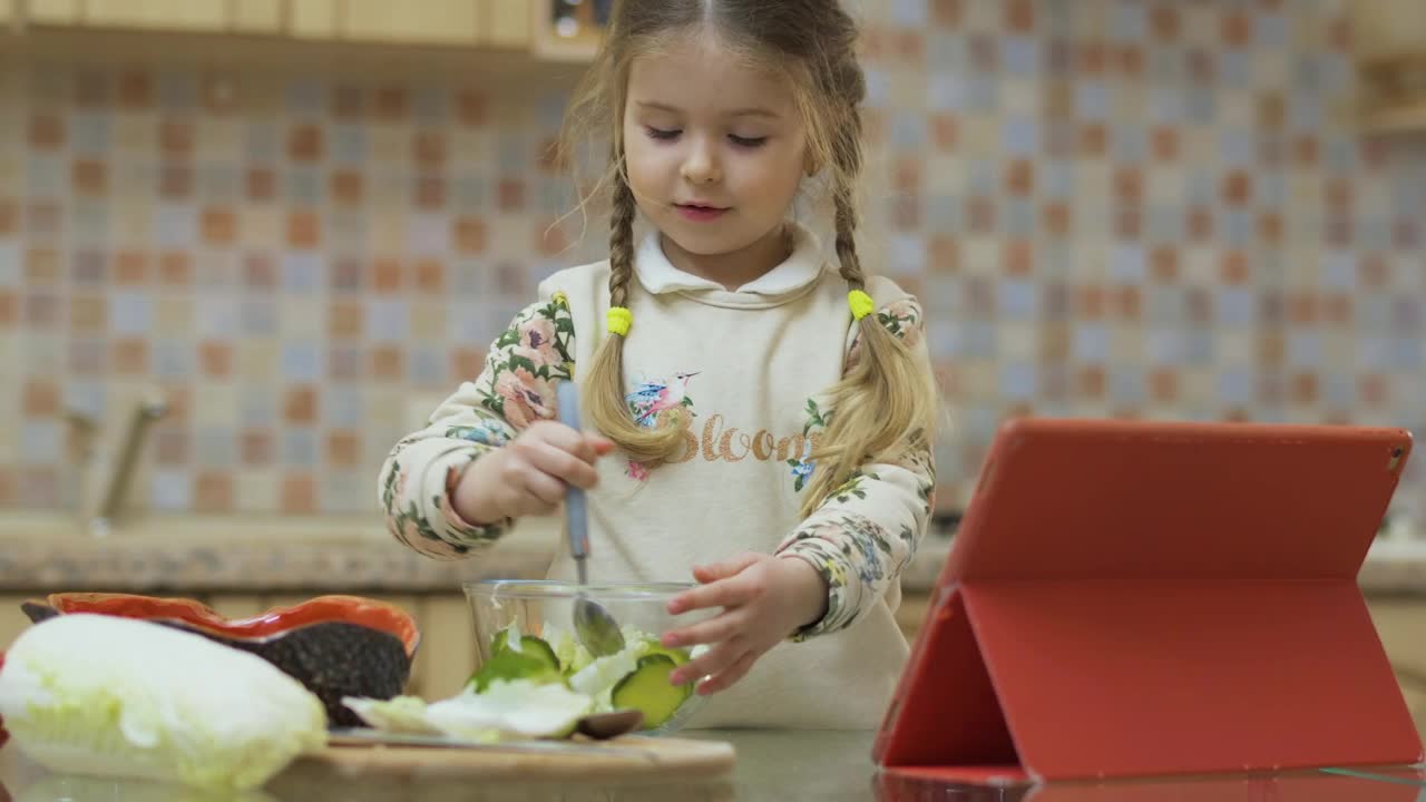 Stock Video Little Girl Stirs Salad With Spoon While Watching Video In Animated Wallpaper - Free Download