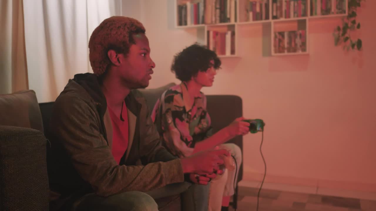 Free Video Stock teenage couple playing video games in the living room Live Wallpaper - Free Download