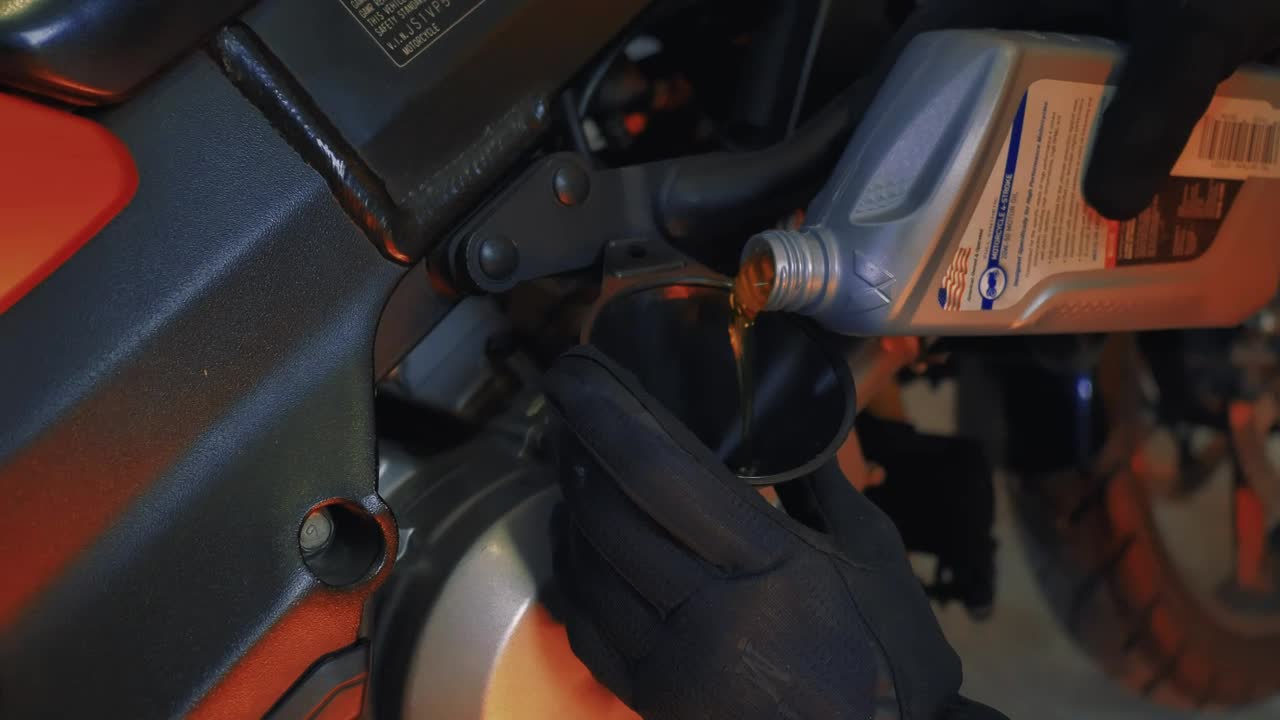 Stock Video Mechanic Changing The Oil Of A Motorcycl Animated Wallpaper - Free Download