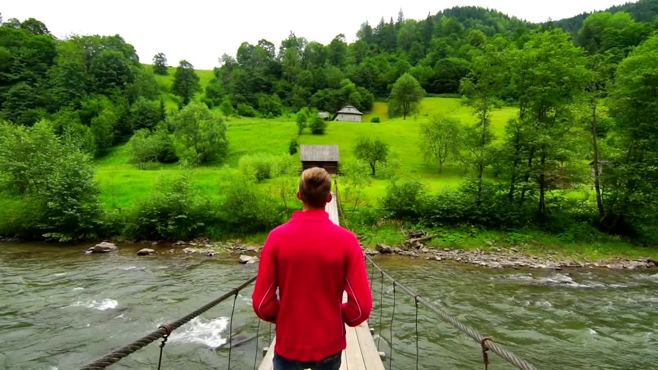 Stock Video Man Walking On A Suspended Bridg Animated Wallpaper - Free Download
