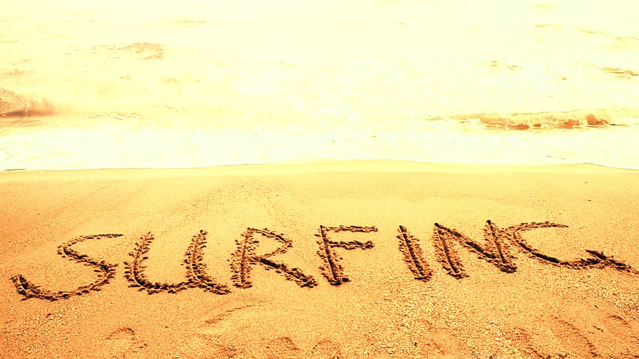 Free Video Stock surfing written in the sand on a sunny beach Live Wallpaper - Free Download