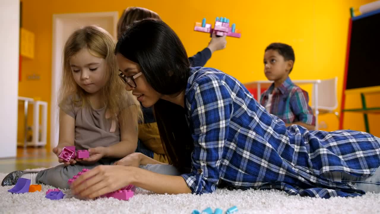 Free Video Stock teacher and students on a carpet playing Live Wallpaper - Free Download