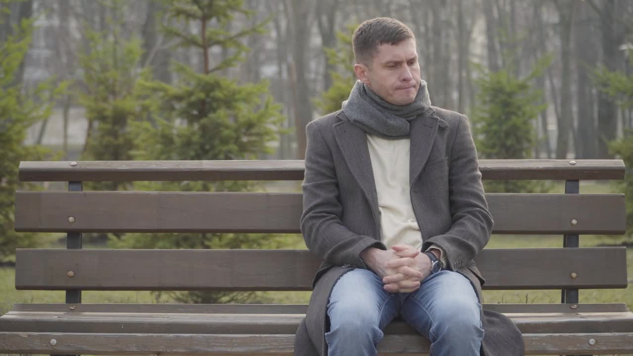 Stock Video Nervous Man Sits On Park Bench Waiting Live Wallpaper - Free Download
