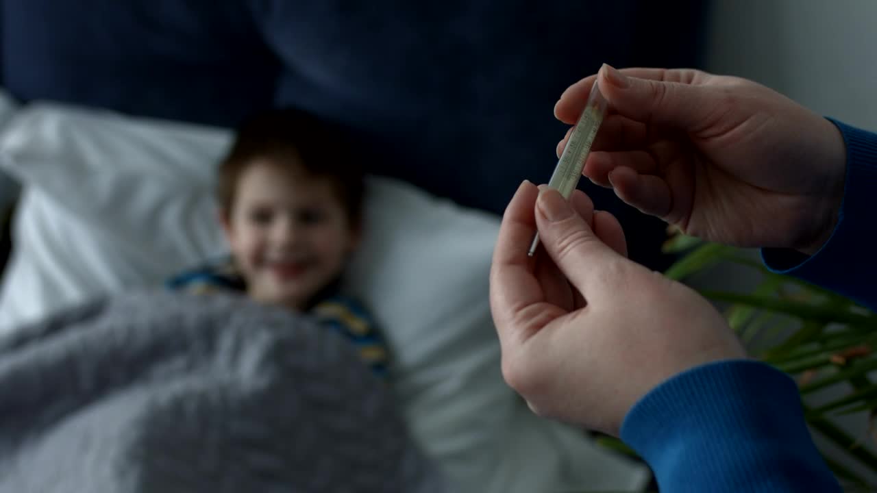 Stock Video Mother Checking Her Sick Sons Thermomete Animated Wallpaper - Free Download