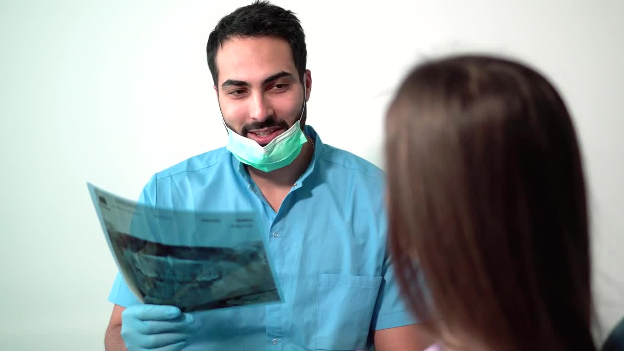 Stock Video Dentist Explaining A Tooth X Ray To A Patient Live Wallpaper For PC - Free Download