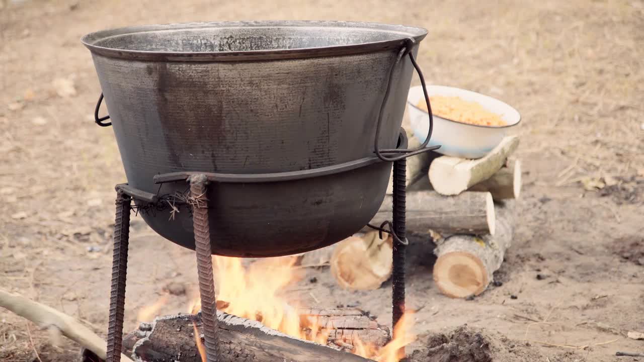 Stock Video Cooking Outdoors With A Cauldron In The Campfire Live Wallpaper For PC - Free Download