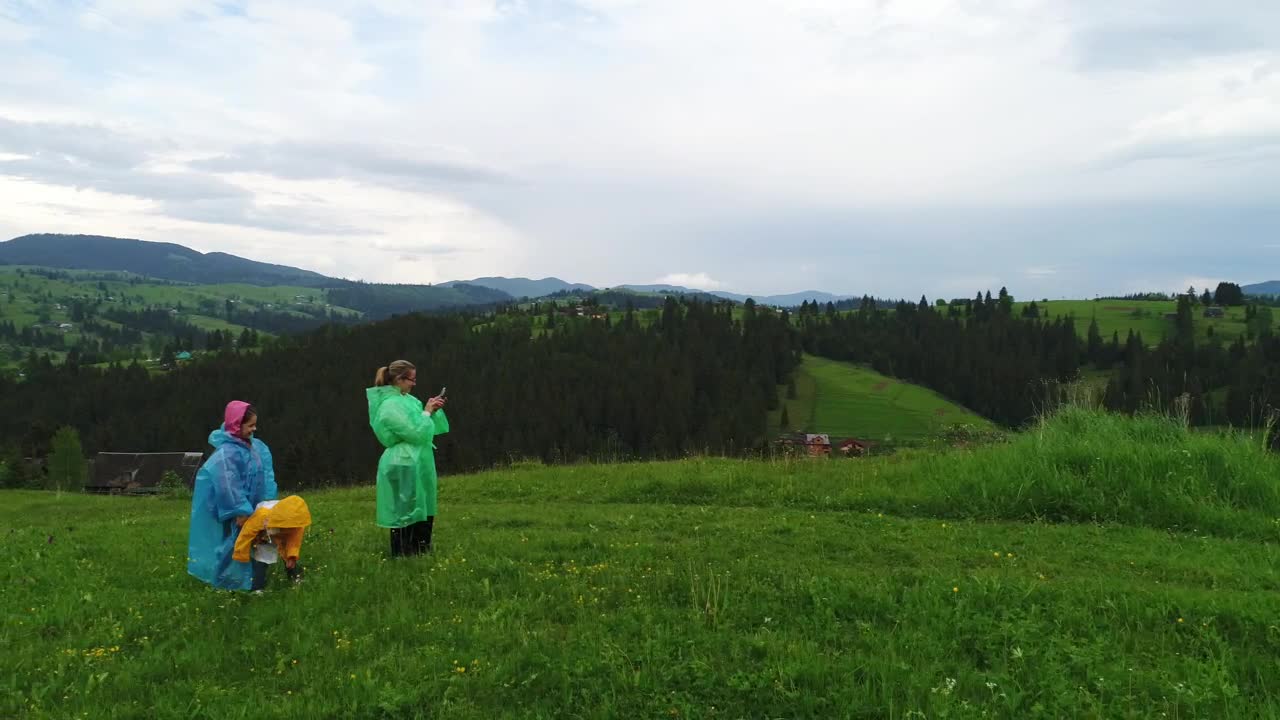 Stock Video Family Wearing Raincoats Taking Selfies In Nature Live Wallpaper For PC - Free Download