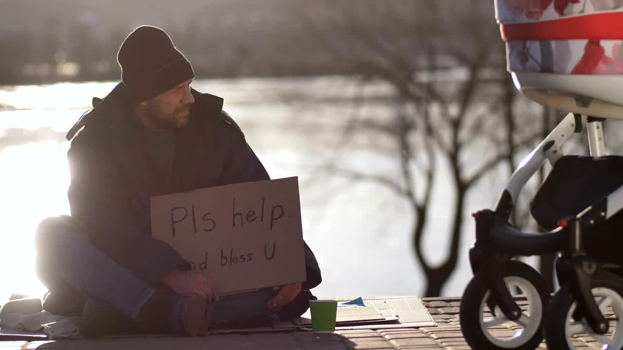 Stock Video Homeless Man On The Street With A Cardboard Sign Animated Wallpaper - Free Download